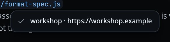A grey toast card with a tick, reading "workshop · https://workshop.example", over the conversation.